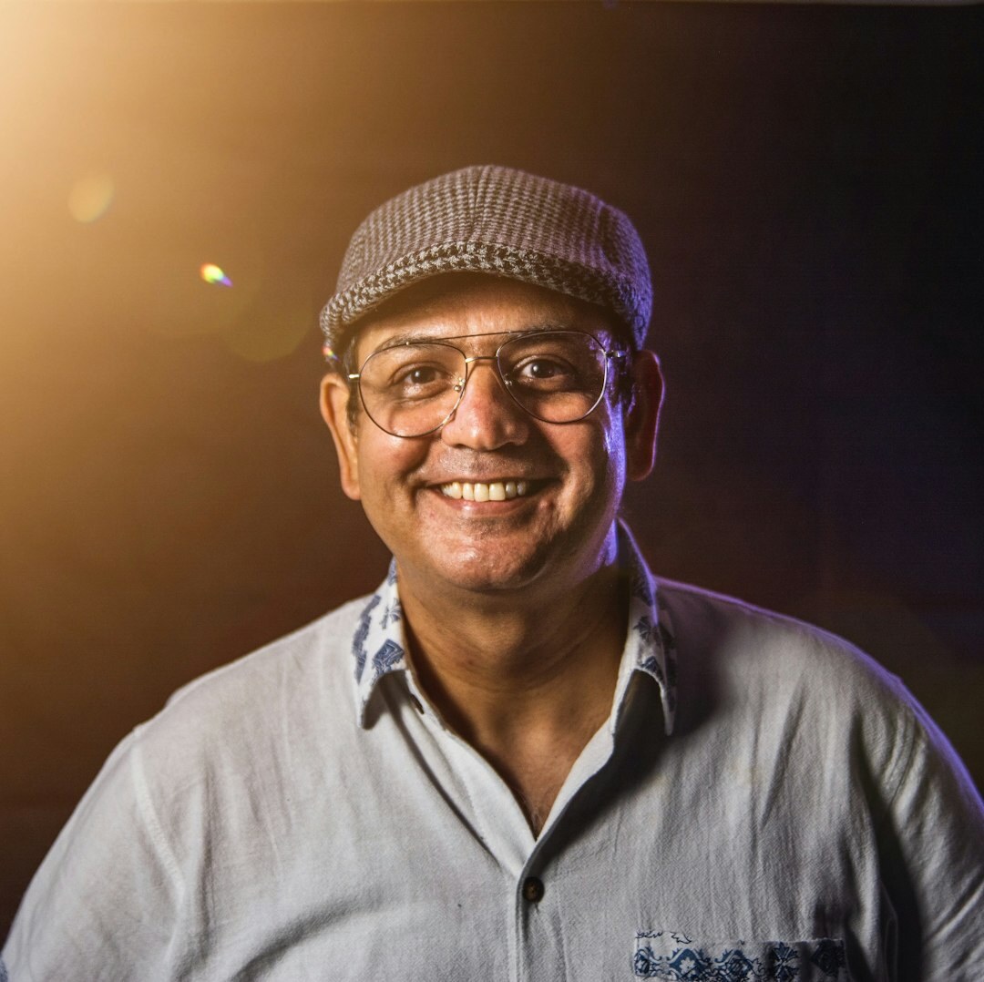 Smiling male senior technology editor with glasses